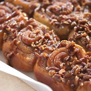 Fluffy cinnamon rolls topped with sweetened pecans