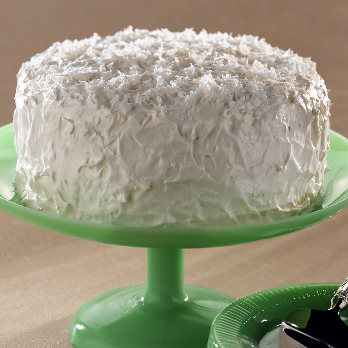 Sweet coconut cake cover with vanilla frosting and coconut shavings on top